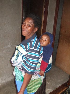 Lydia uses her blanket to carry her son.